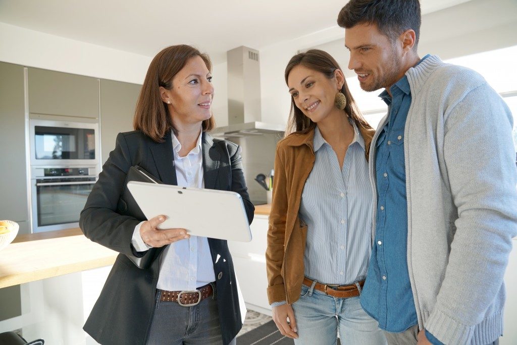 agent showing house to couple