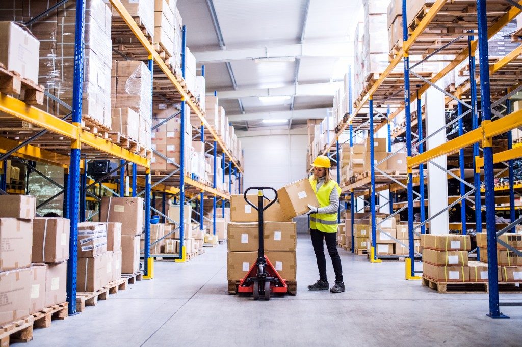 Woman loading boxes in warehouse