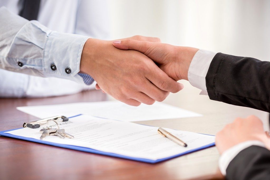 Real estate agent shaking hands with the client