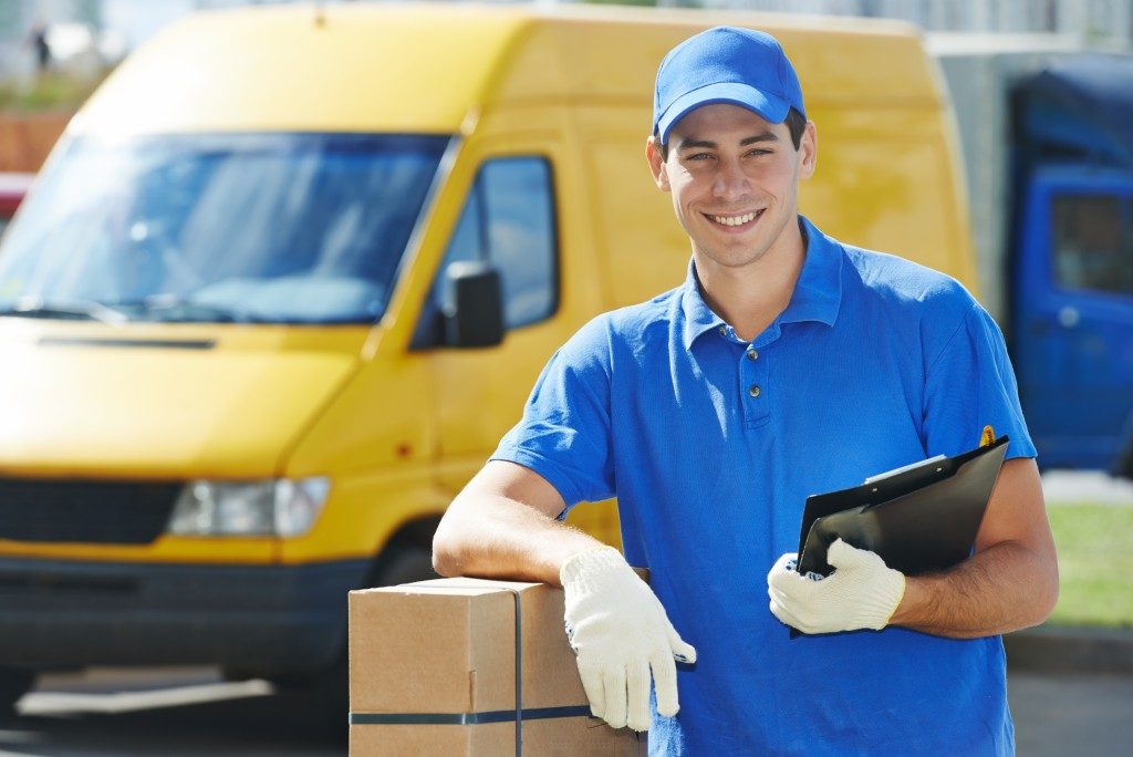 man working for shipping company is smiling
