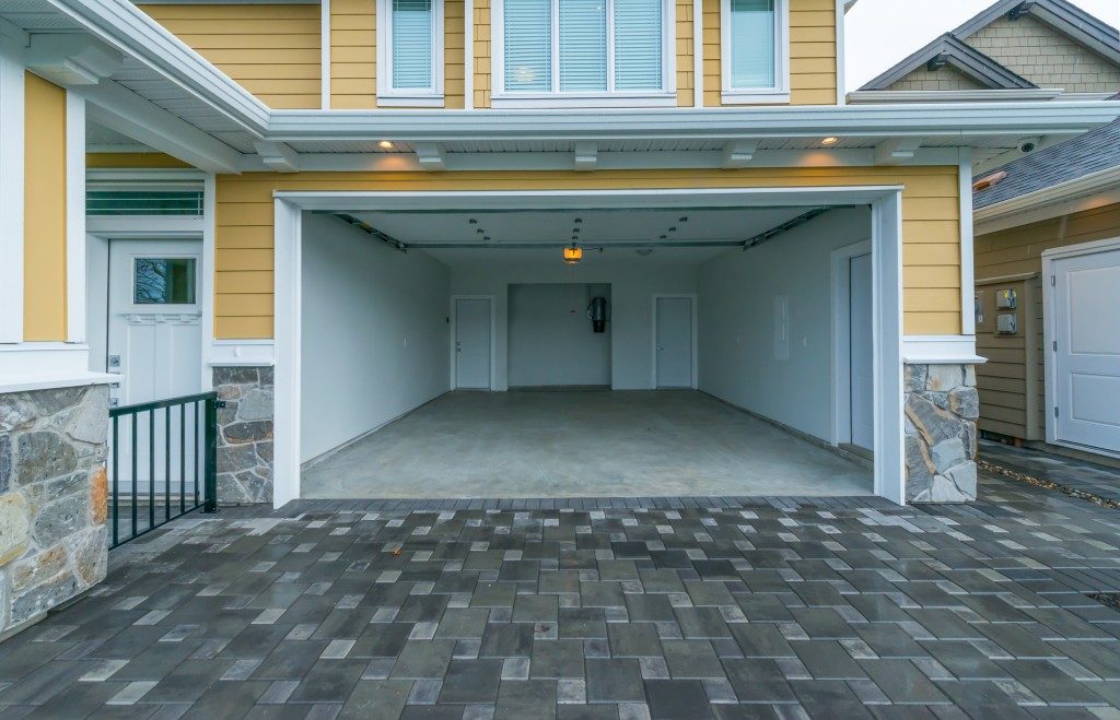 yellow house with open garage doors