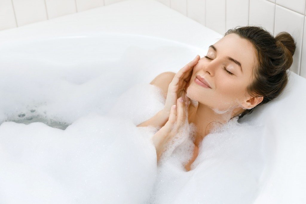 Woman taking a bubble bath