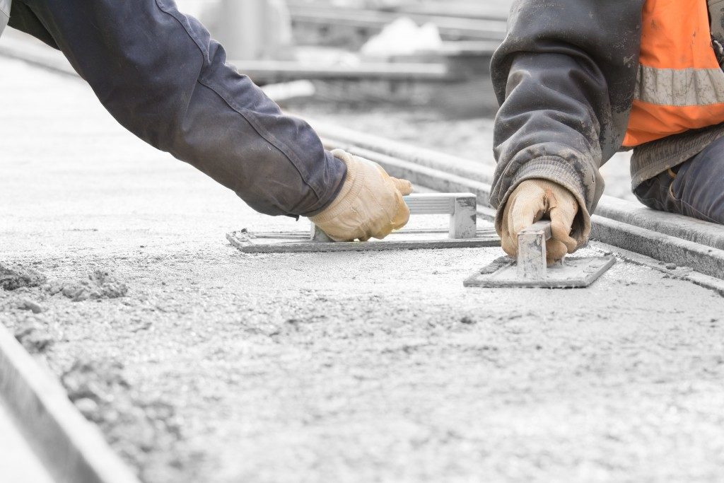 workers flattening the concrete