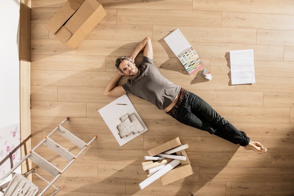 man on the floor of home being renovated