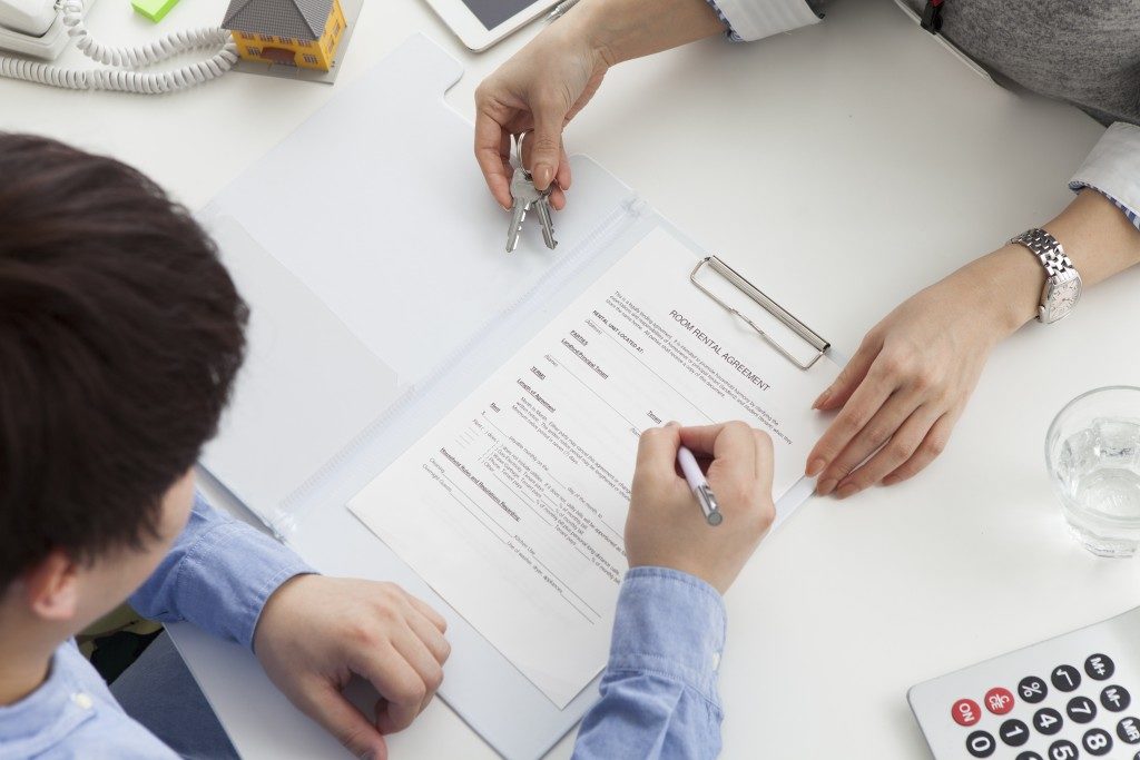 Man signing contract of land sale