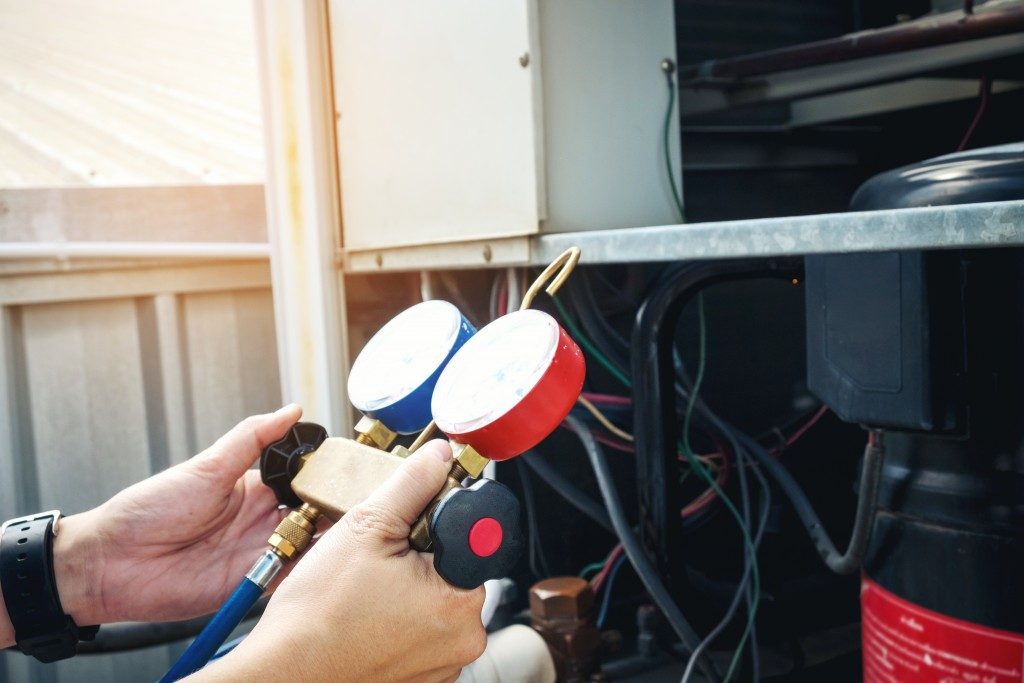 hands of a person reparing a boiler