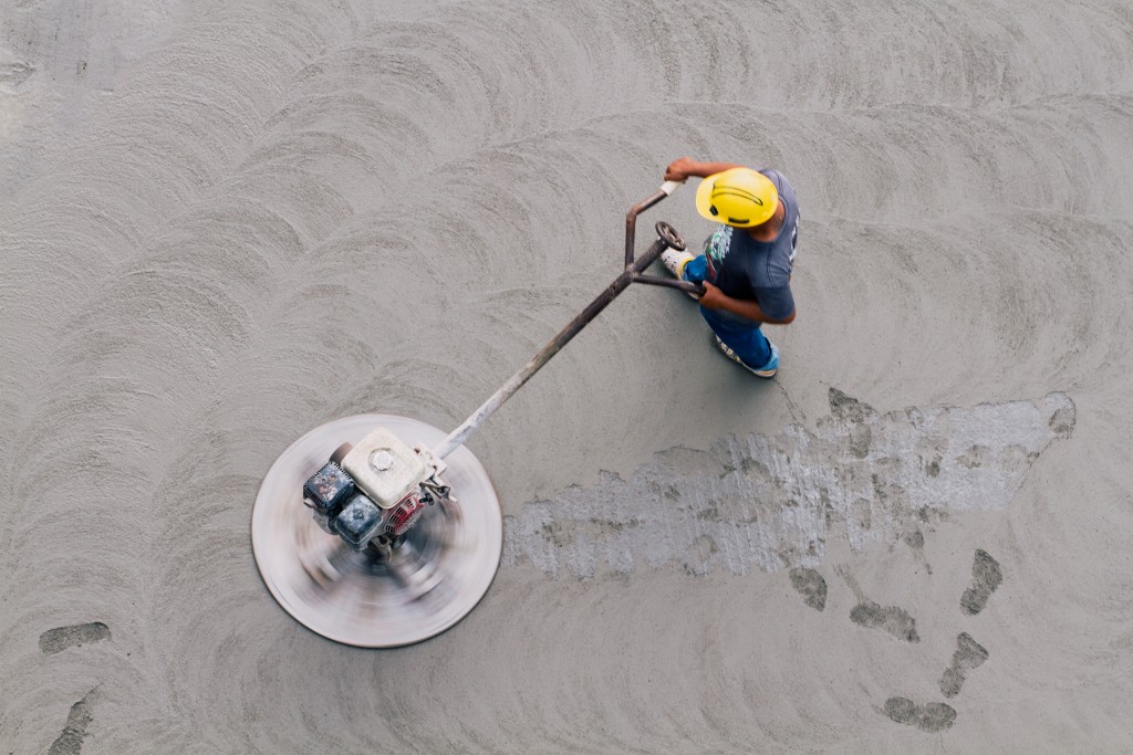 man smoothing out concrete