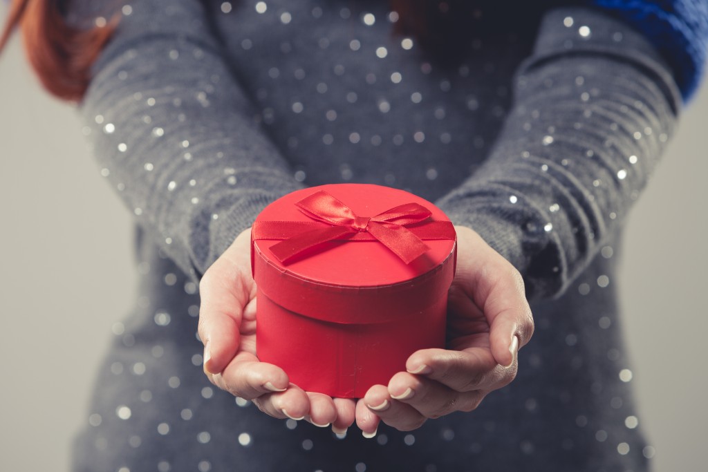 woman handing a gift