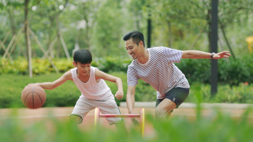 father and son playing basketball