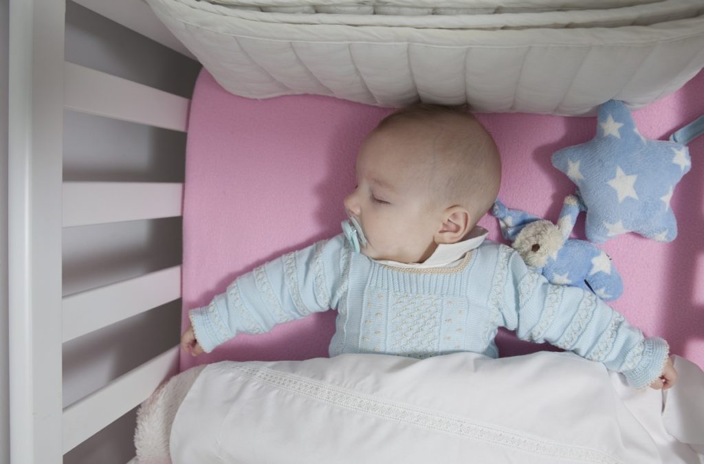 baby asleep in a crib
