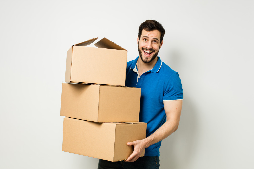 man carrying boxes