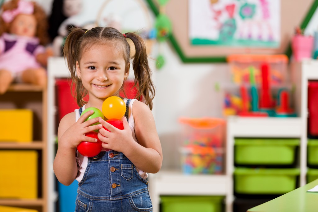 kid holding toys