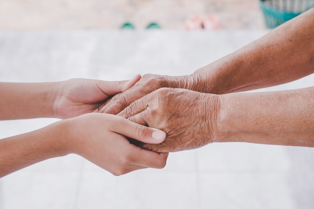 holding hands of senior