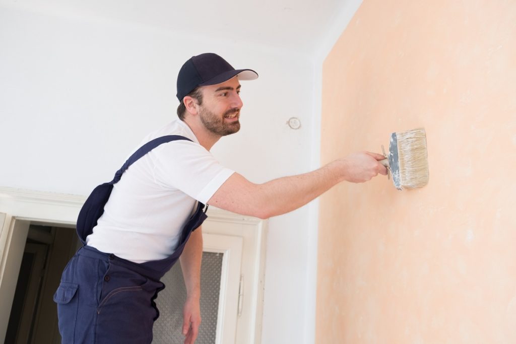 man painting the wall