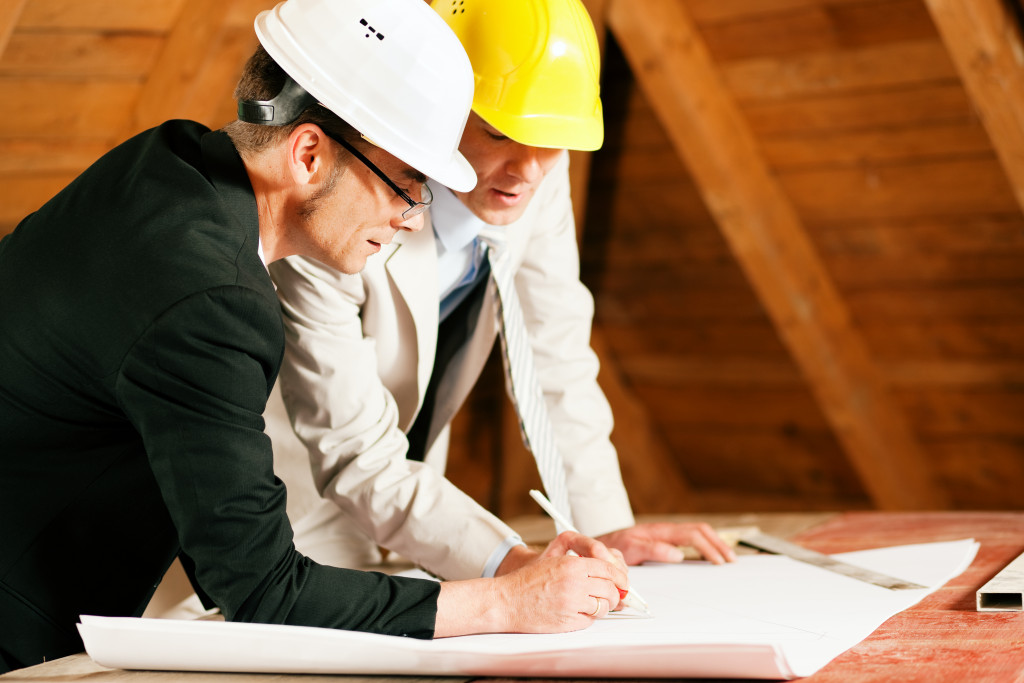 engineer and contractor discussing about the building plan