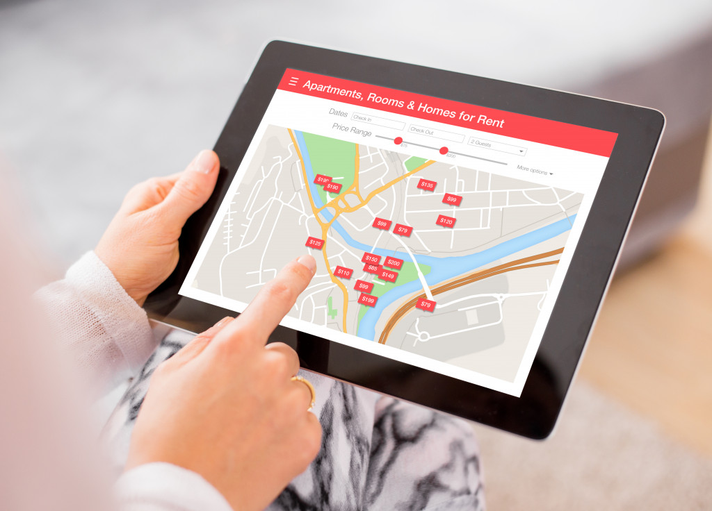 a loan provider looking at vehicle location on a digial ablet
