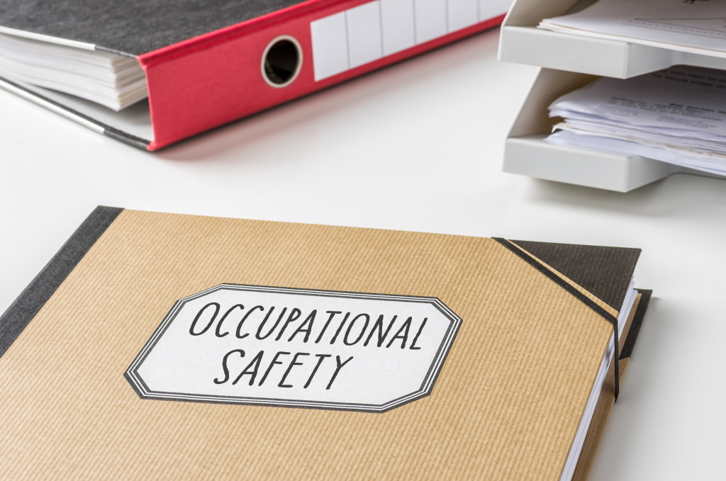 A folder on table with the label of occupational safety with other files