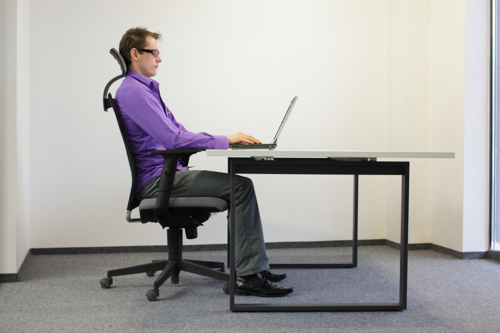 employee sitting on his desk in the office