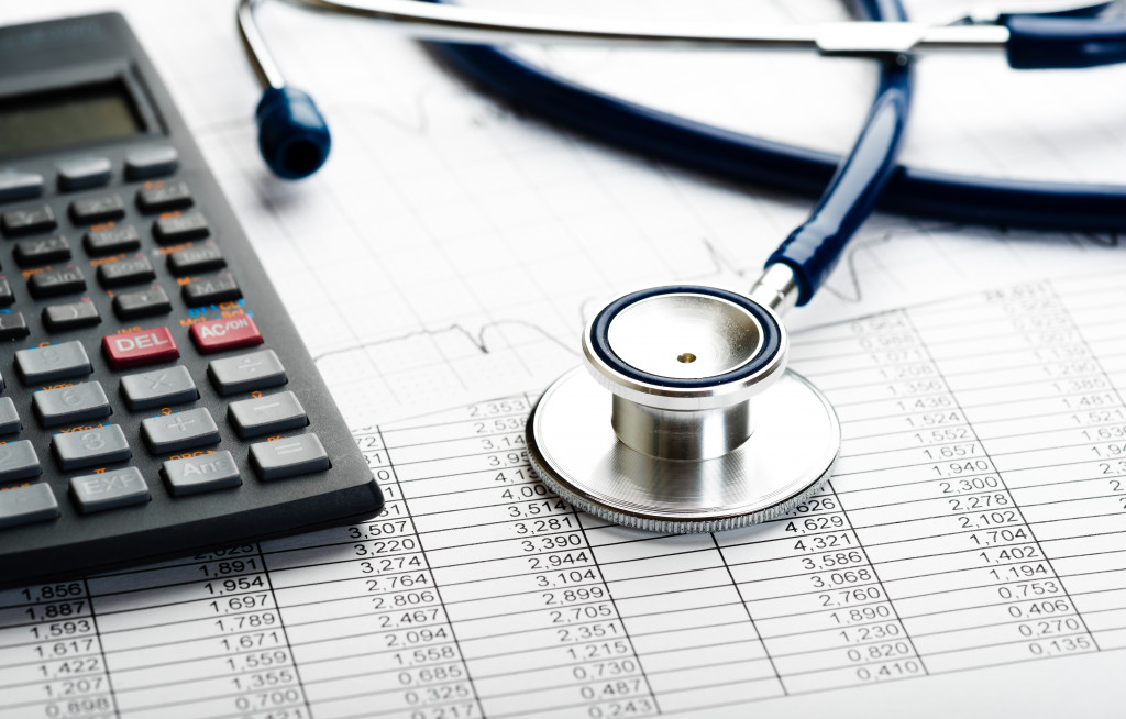 Health care costs. Stethoscope and calculator symbol for health care costs or medical insurance