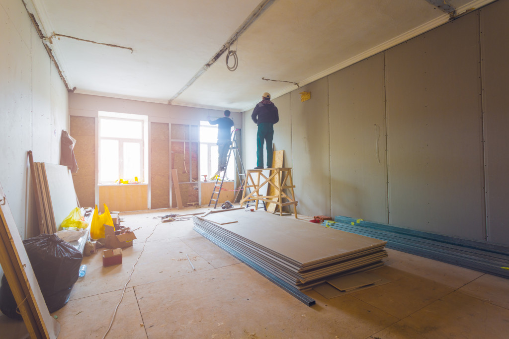 men working in a room that's under renovation