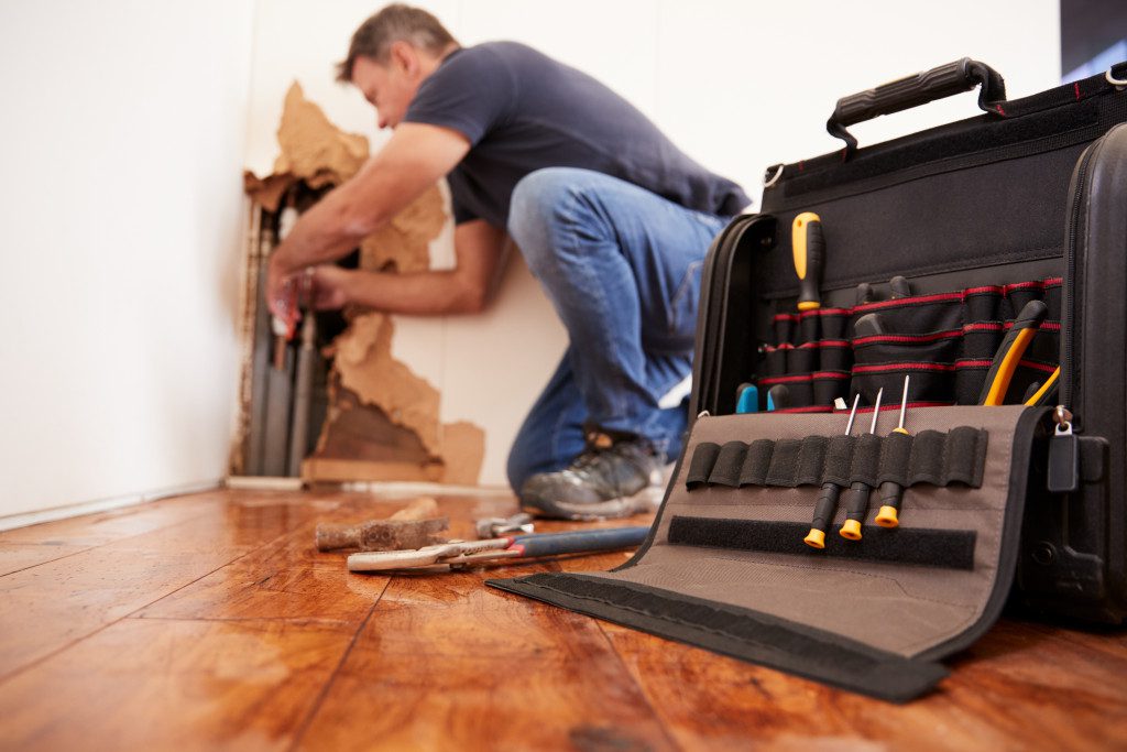 A man with his professional tool box working in a home