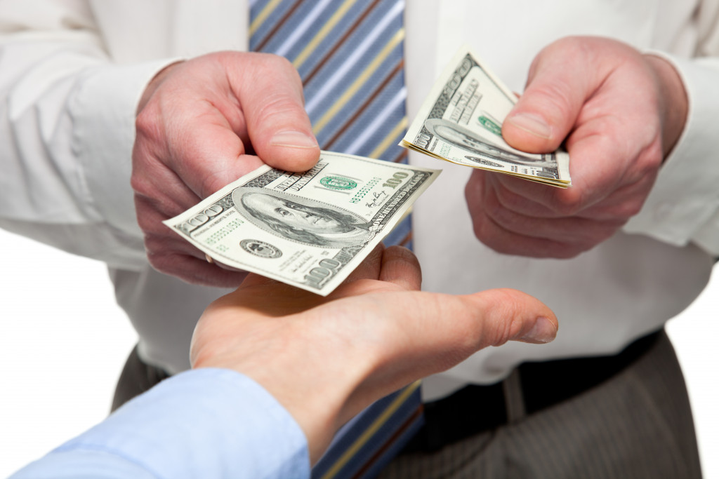 Human hands exchanging money - closeup shot