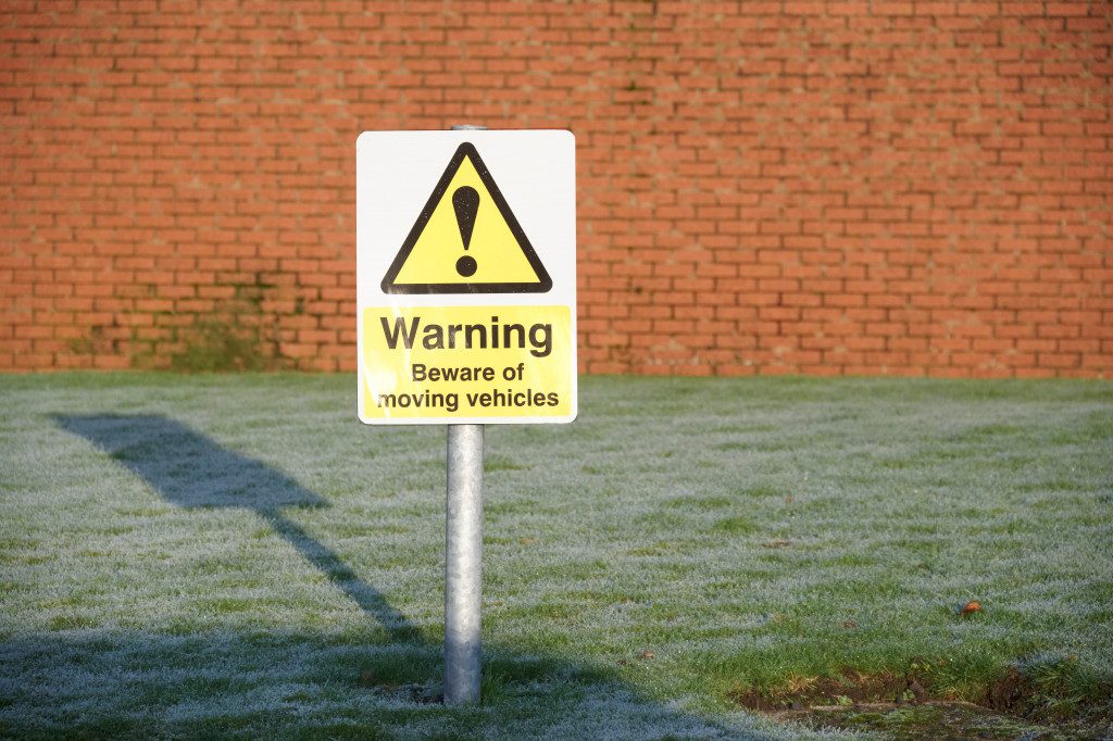 a warning sign placed outside a manufacturing area