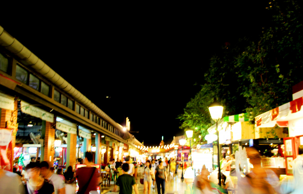 blurred moving shopper at night bazaar market in thailand