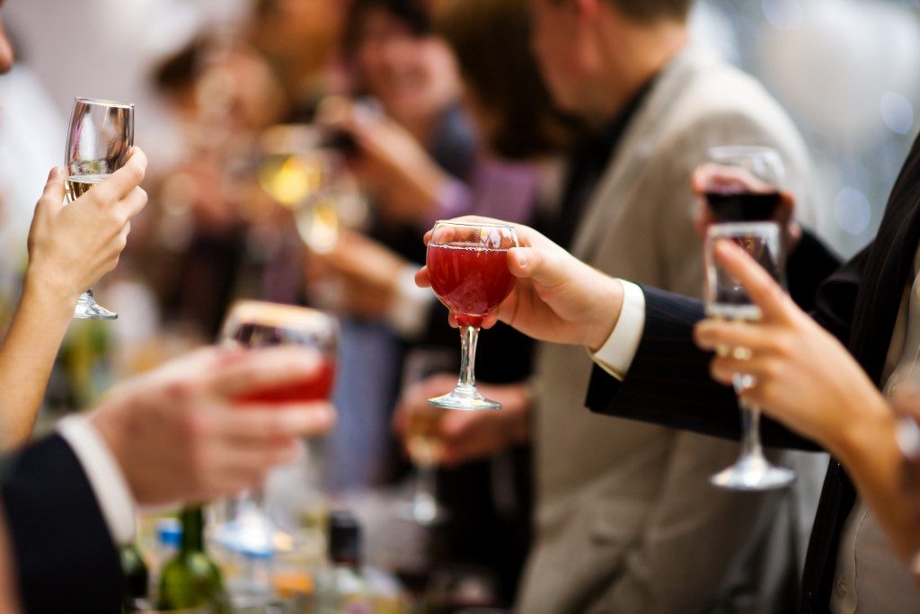 Holiday Event people cheering each other with champagne and wine