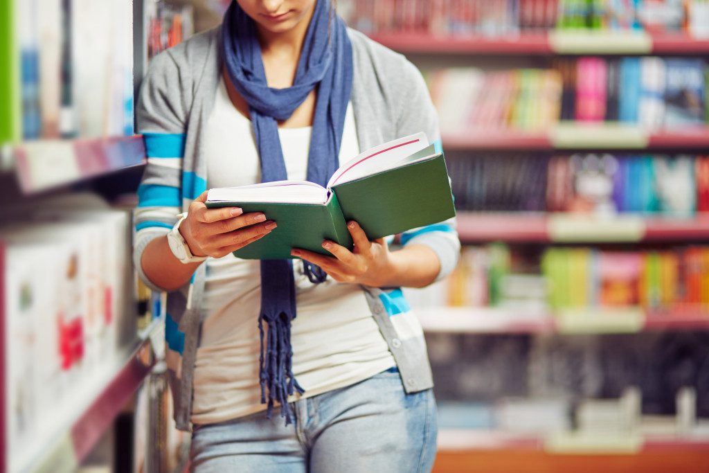 A young university girl reading studying in library 