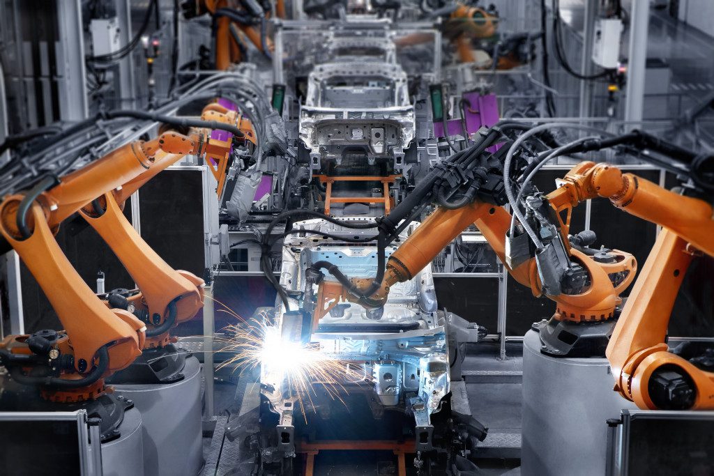 Portrait of a car manufacturing factory where robots manufacturing cars