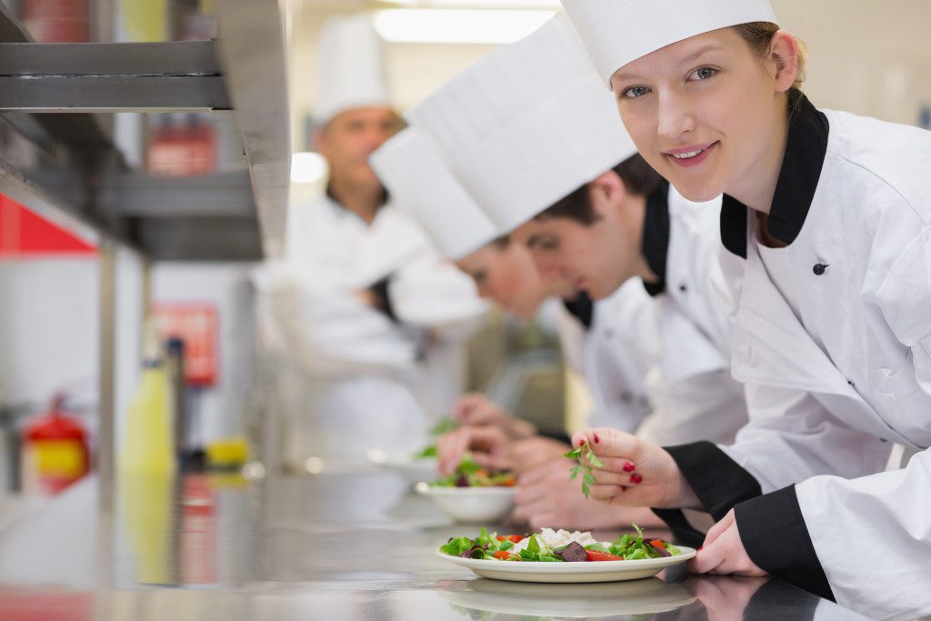 line of kitchen staff in the assembly line