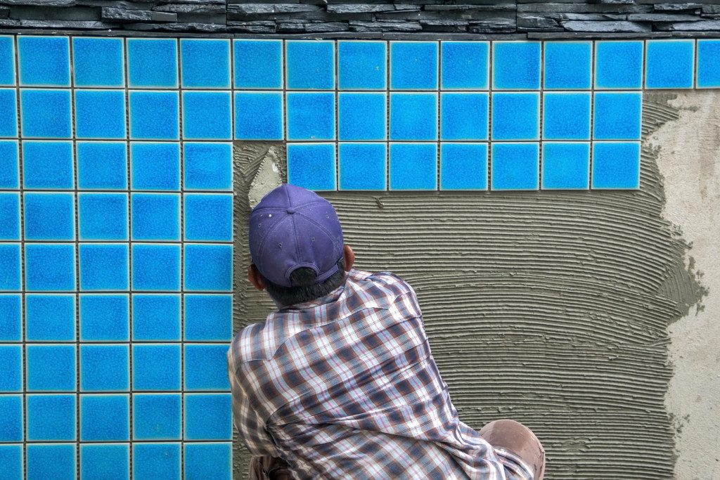 A pro installing pool tiles