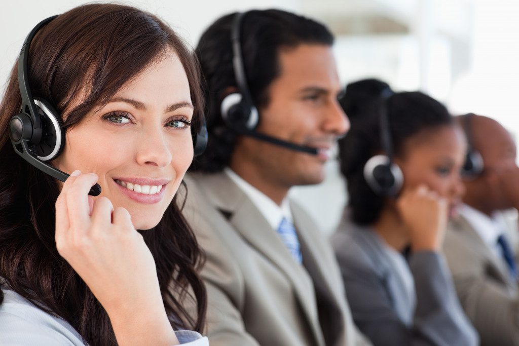 Happy woman wearing headset working as a customer service executive 