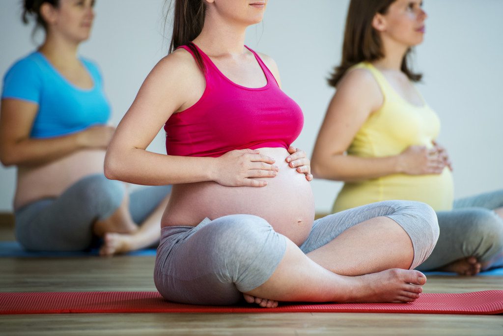 Multiple pregnant women doing yoga