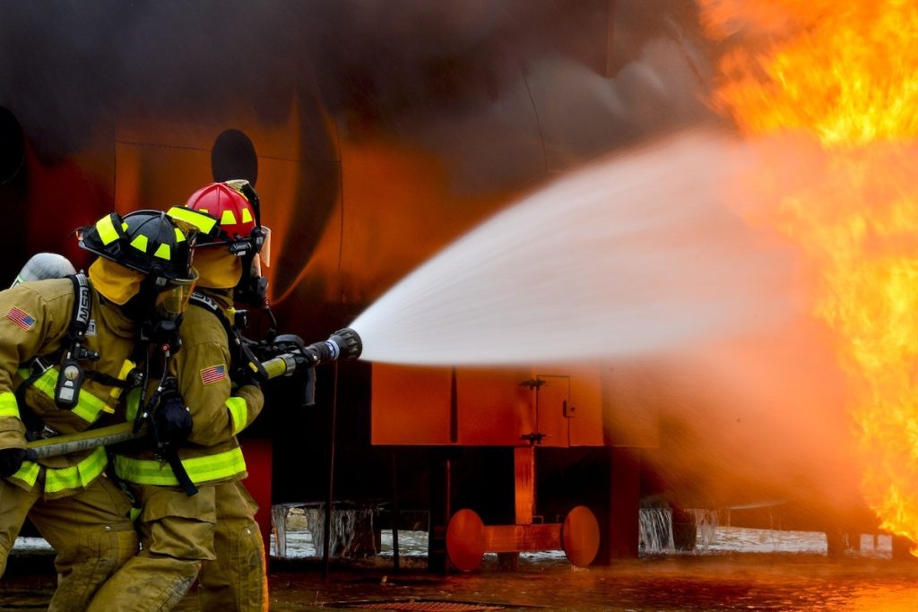 Firemen Blowing Water on Fire