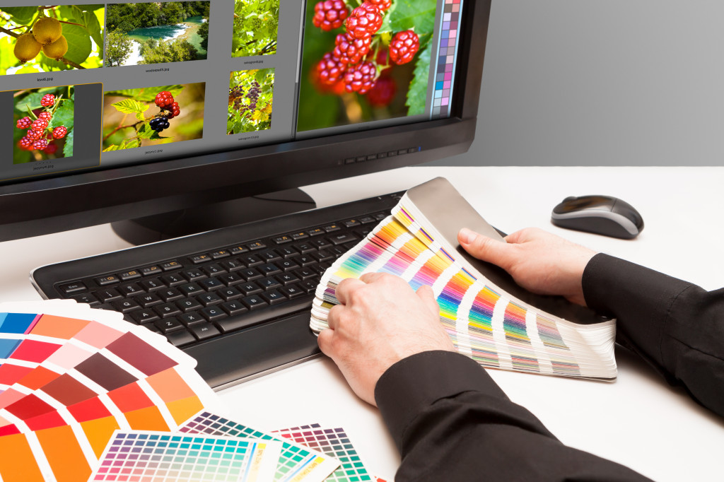 A graphic designer looking at color samples
