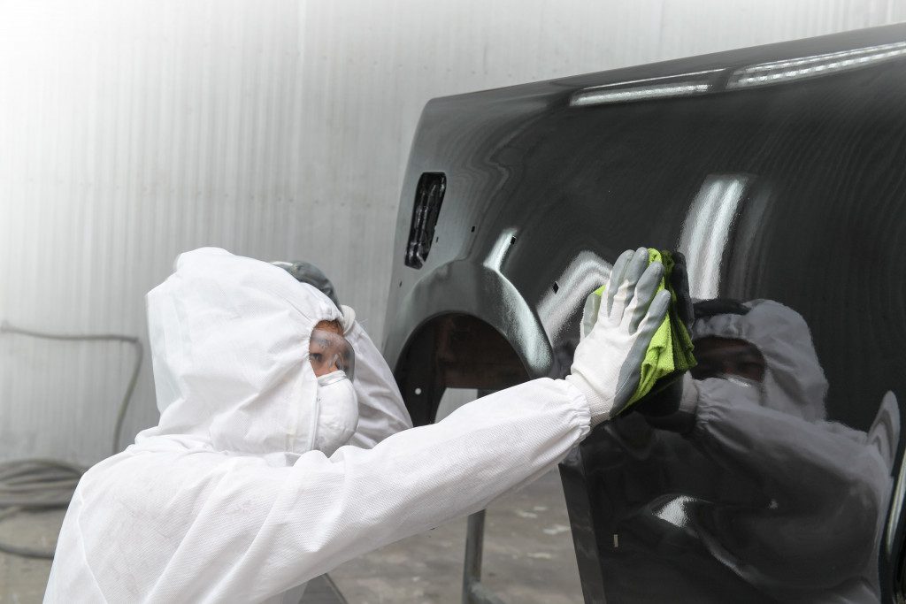 man applying car paint protection