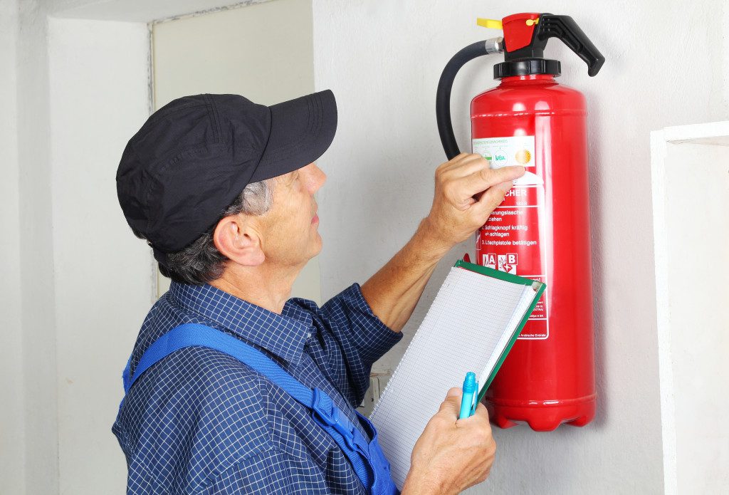 inspector checking fire extinguisher