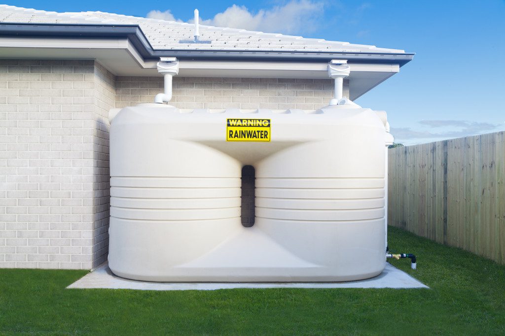 rainwater harvesting tanks in a house backyard