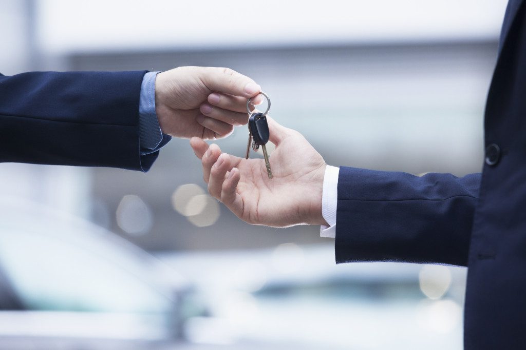 company car keys being handed to another entrepreneur