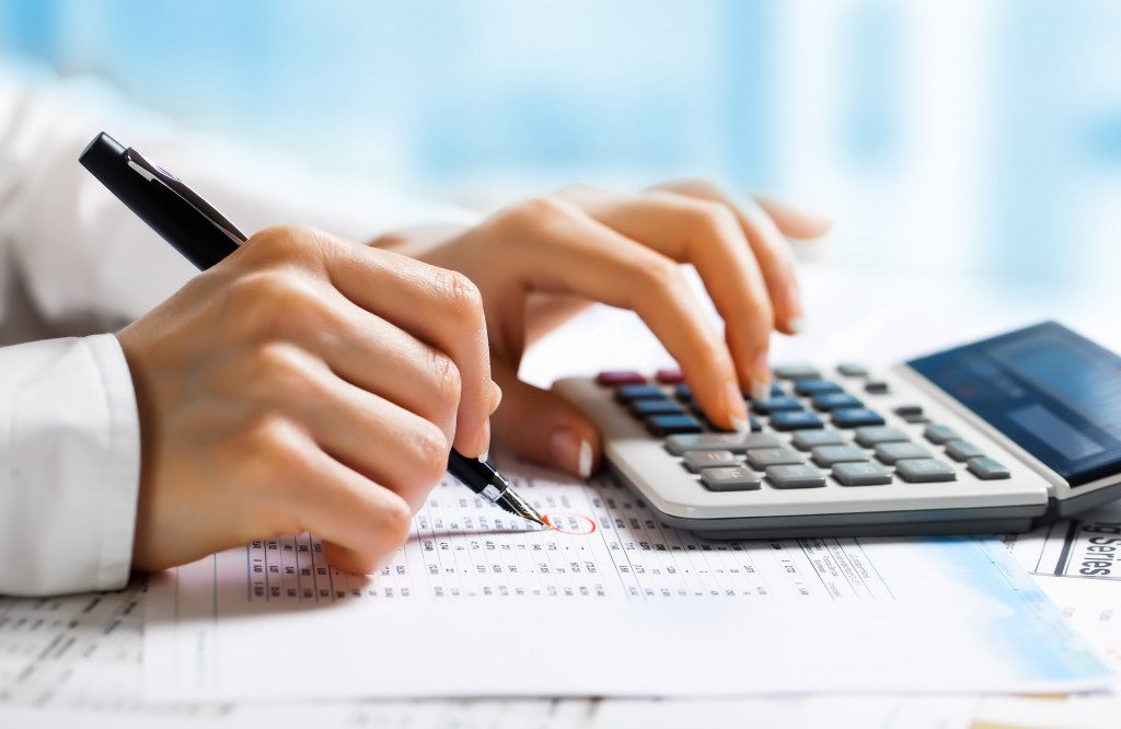 A person calculating their business finances