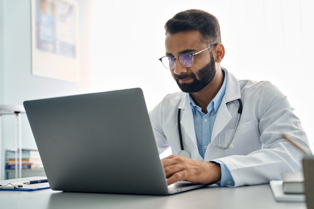 a doctor working using laptop